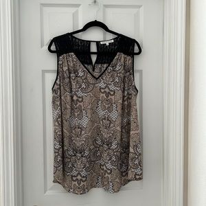 Sleeveless top with black lace on shoulders and back.